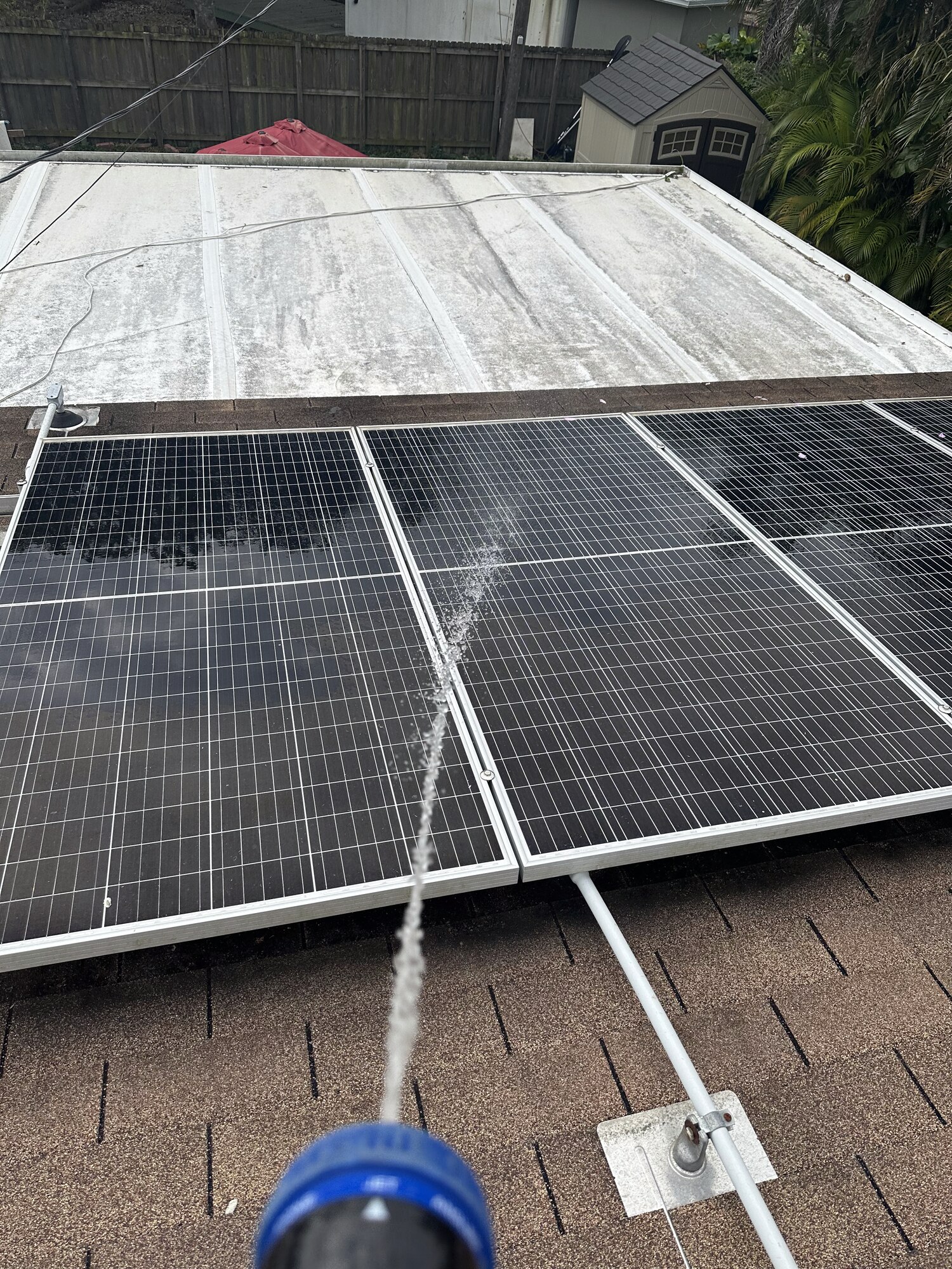 Dirty roof next to a freshly cleaned solar panel